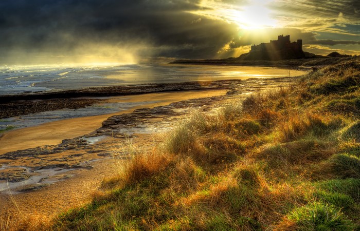 Bamburgh Castle on the coast with dramatic sky