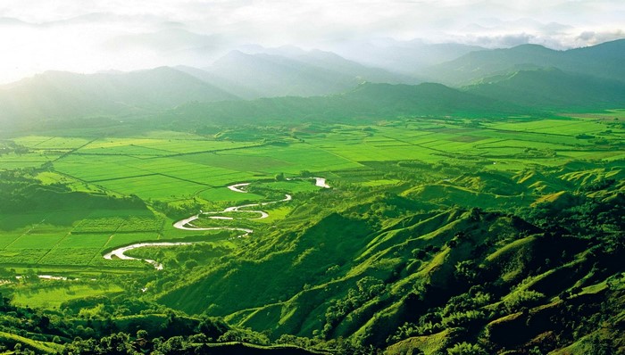 Green valley with winding river and mountains