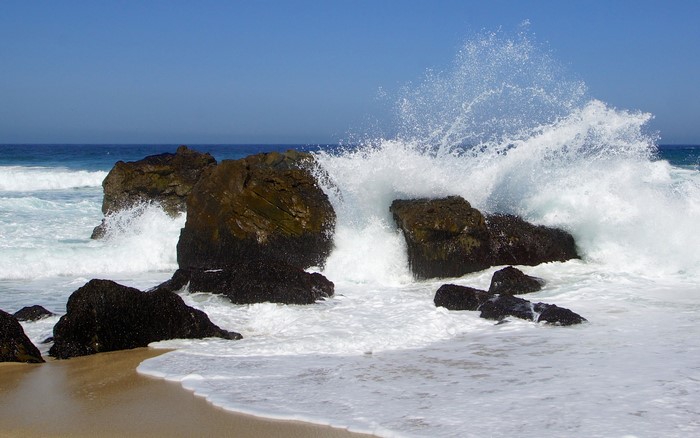 Waves crashing on rocks at the beach