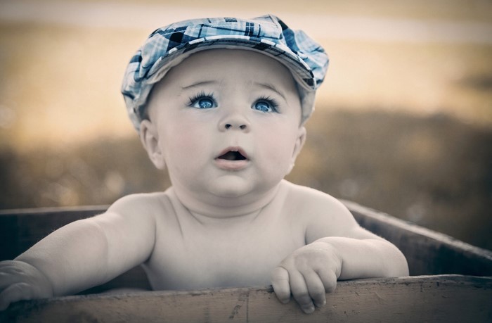 Baby wearing a plaid cap