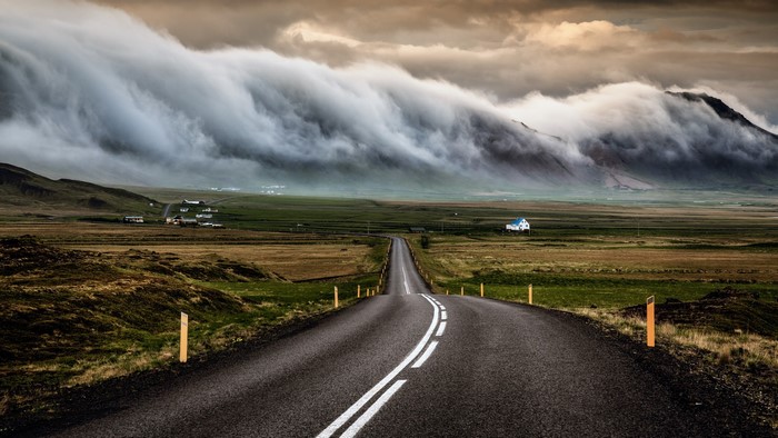 Road through Iceland with dramatic clouds