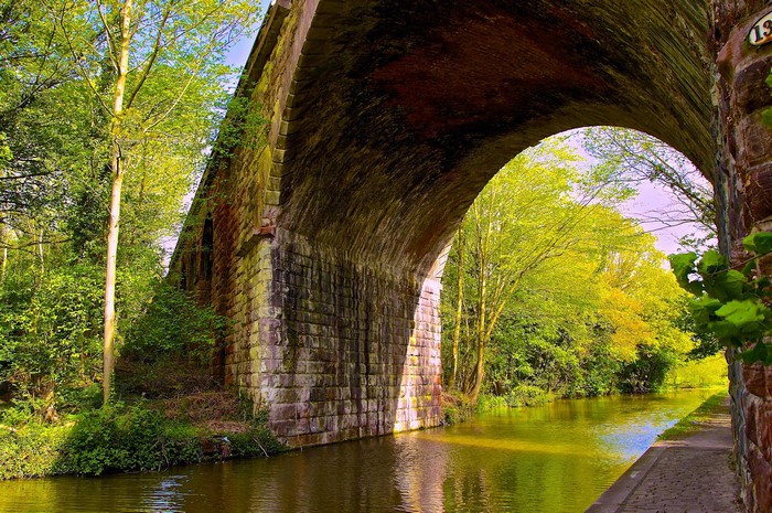 Stone bridge over a canal with trees