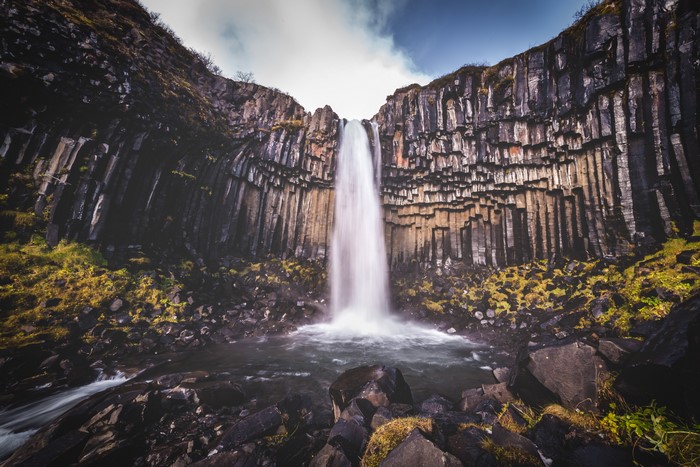 Waterfall cascading over basalt columns