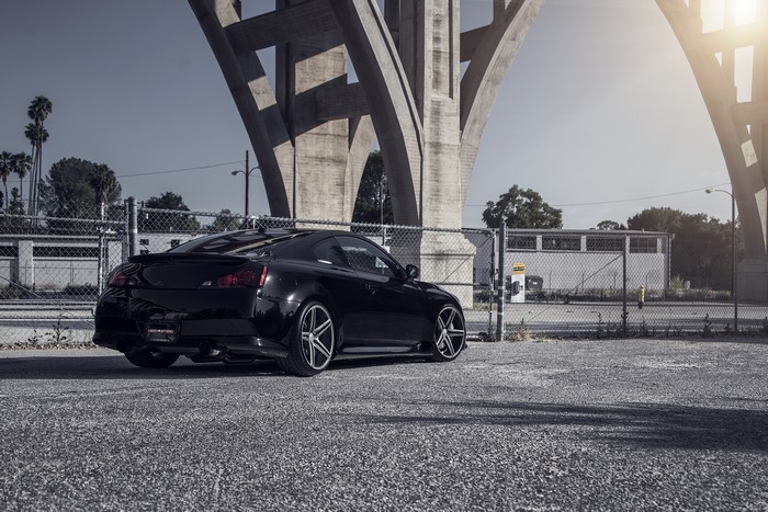 Black Infiniti G37 CV5 parked under a bridge