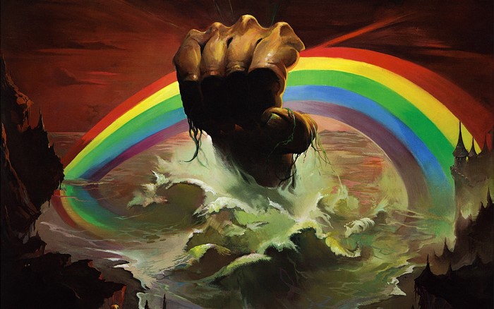 Fist emerging from waves under a rainbow
