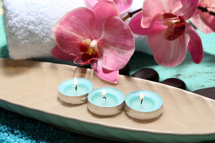 Orchid flowers with spa candles and stones