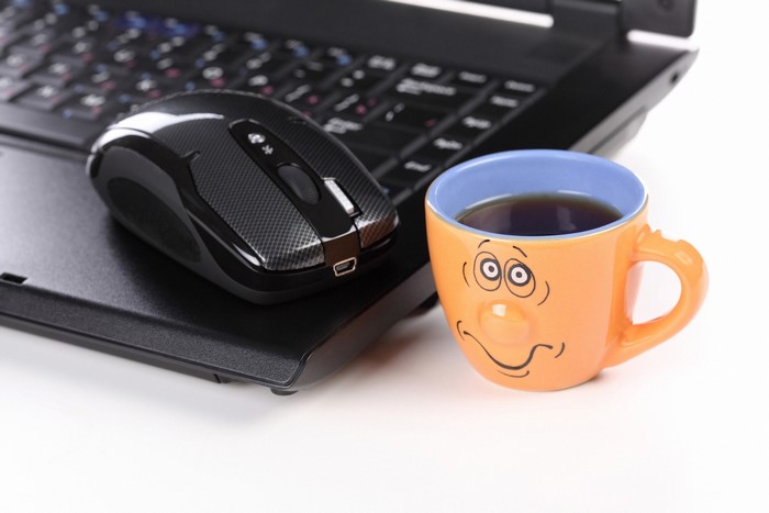 Laptop, Mouse, and Coffee Cup with Smiley Face