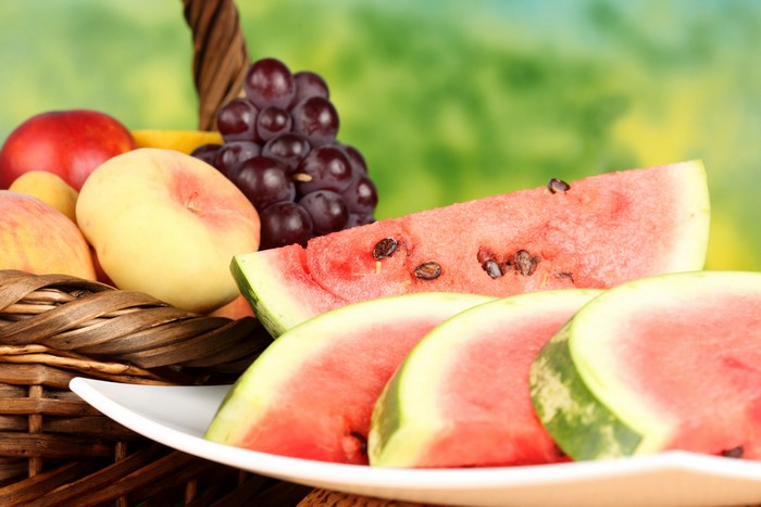 Fruit basket with watermelon, grapes, and peaches