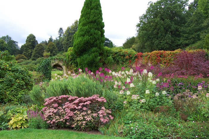 Garden with stone archway and colorful flowers