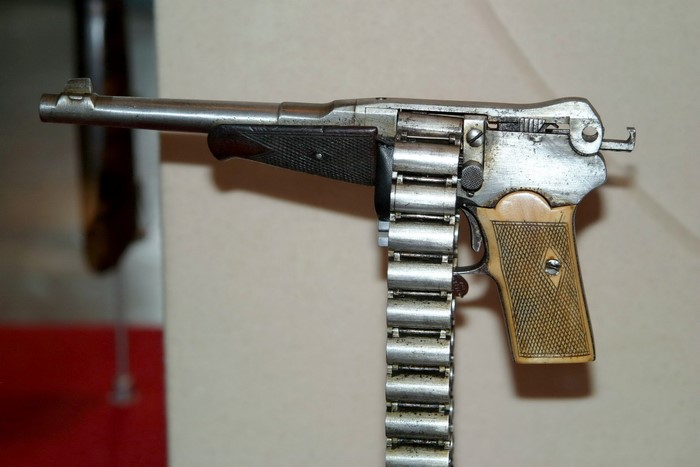 Pistol with ammunition belt