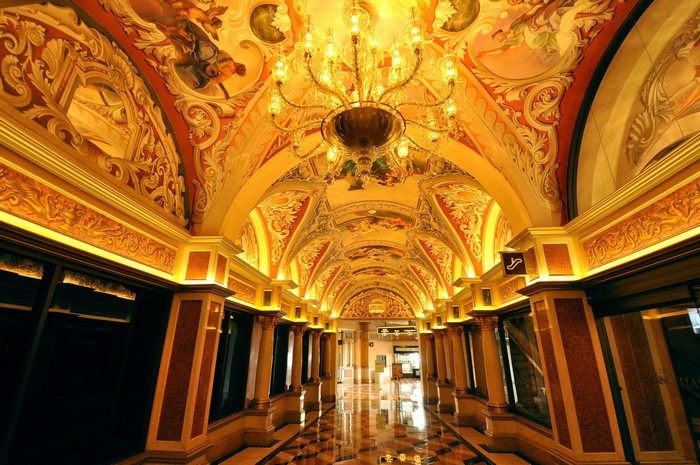 Grand hallway with ornate ceiling and chandelier