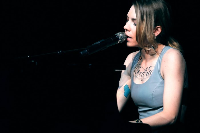 Skylar Grey singing into a microphone