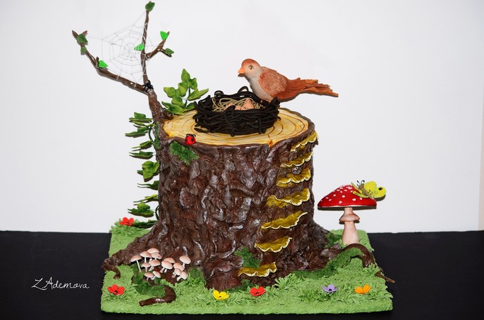 Tree stump cake with bird, nest, mushrooms, and spiderweb