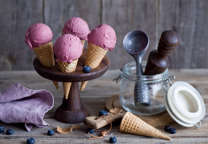 Blueberry ice cream cones on a wooden stand