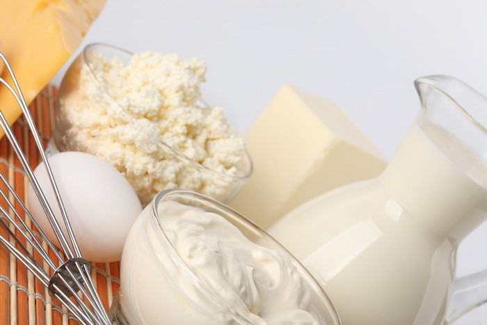 Dairy products and egg with whisk