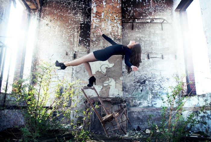 Woman levitating in abandoned building