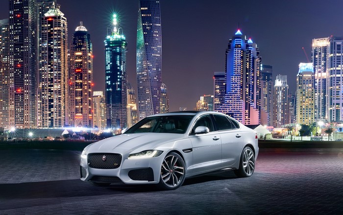 White Jaguar XF 2016 parked in Dubai at night