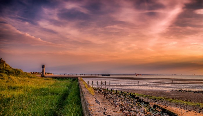Spurn Head lighthouse and coast at sunset