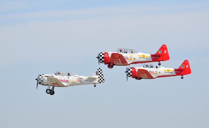 Three Aerobatic Airplanes in Flight