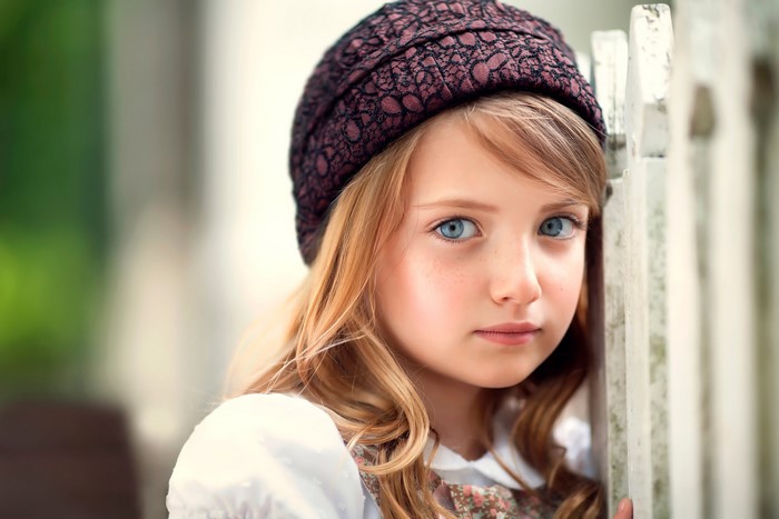 Thoughtful Girl in Winter Hat with Blue Eyes