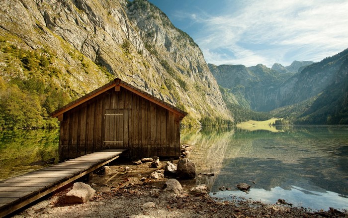 Wooden boathouse on a lake with mountains