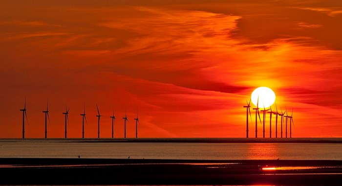 Offshore wind turbines at sunset over the sea