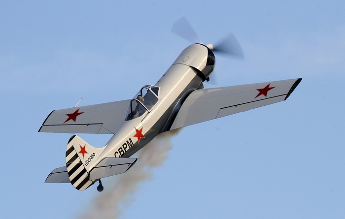 Yakovlev Yak-50 airplane with red stars in flight