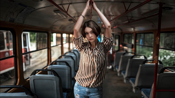 Woman in striped shirt inside a bus