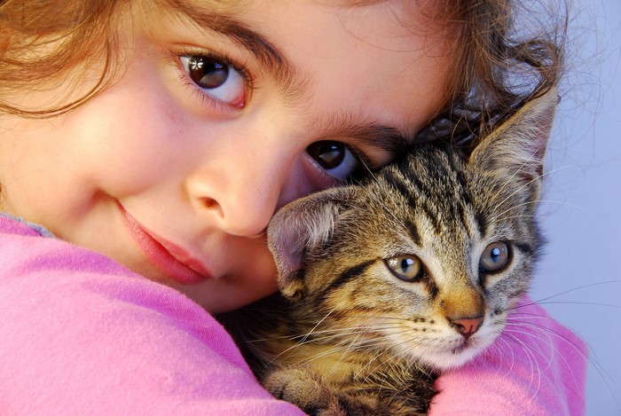 Girl Hugging a Kitten