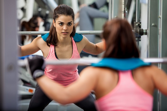 Woman lifting weights in a gym
