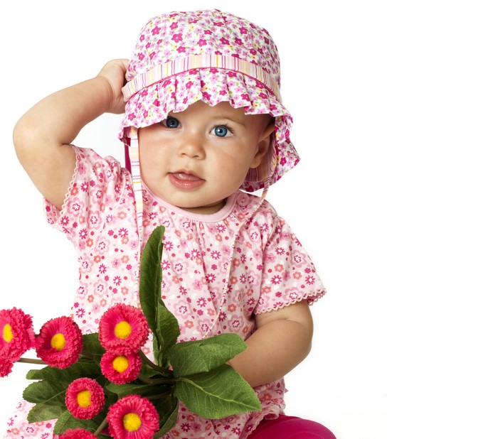 Baby girl in a floral hat and dress with flowers