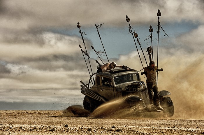 Mad Max: Fury Road desert scene with men on vehicle