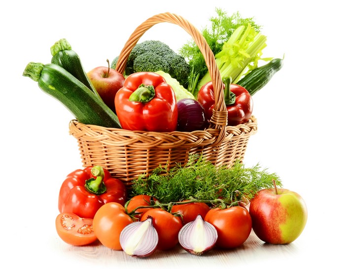 Wicker basket filled with fresh vegetables and fruits