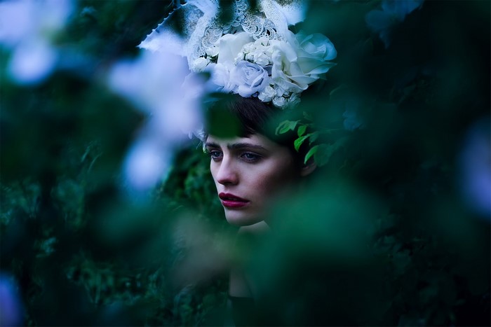 Woman with flower crown in foliage