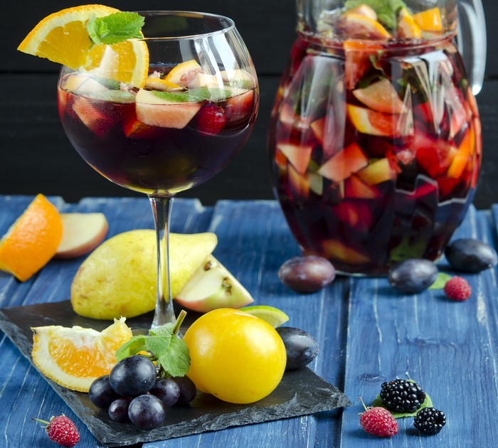 Sangria in a glass and pitcher with fruits