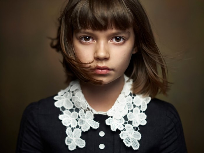 Portrait of a Brown-Haired Girl with a White Floral Collar
