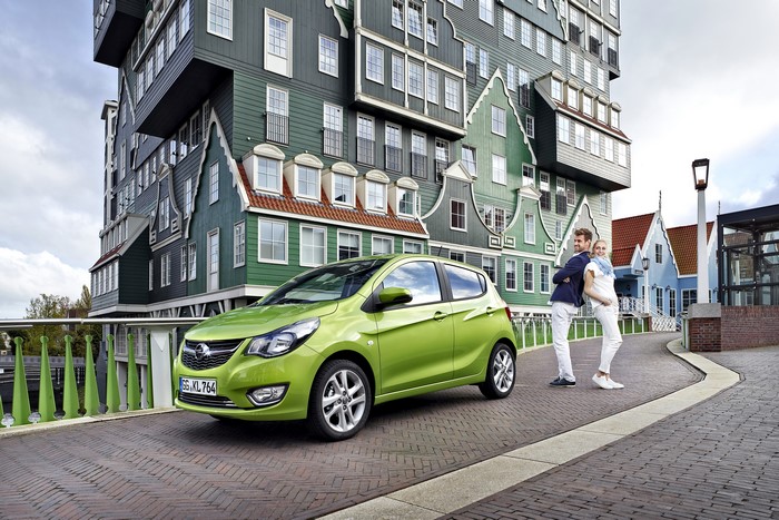 Opel Karl with couple in front of Dutch-style buildings