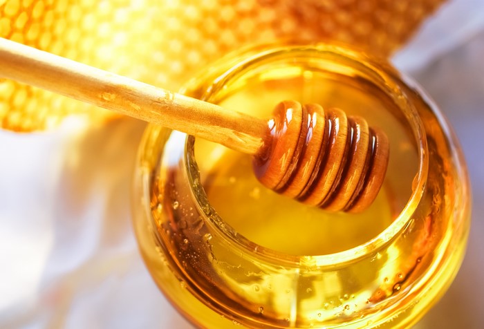 Honey in a jar with a dipper