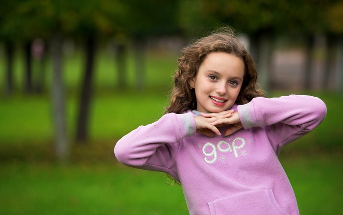 Young girl in a pink Gap hoodie outdoors