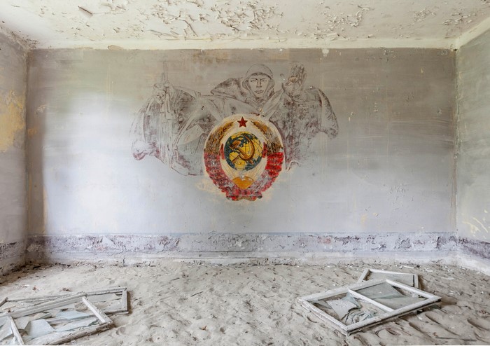 USSR emblem and figures painted on a dilapidated wall
