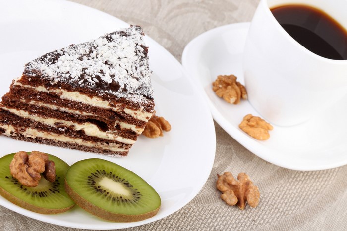 Chocolate cake with kiwi, nuts, and coffee