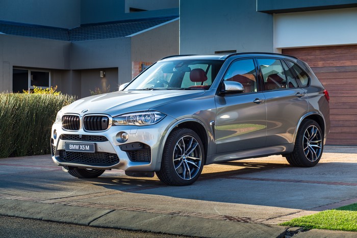 Silver BMW X5 M parked in driveway
