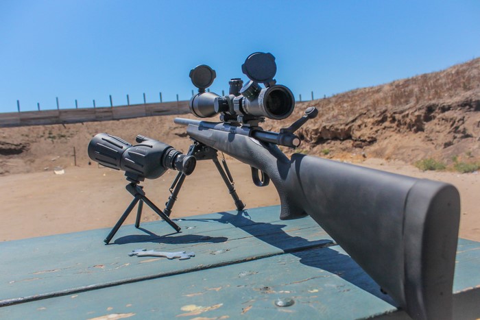 Remington 700 sniper rifle and spotting scope on table