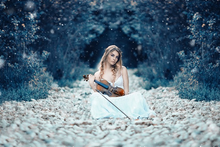 Woman with Violin in a Rocky Forest