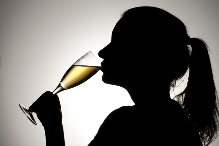 Silhouette of a woman drinking champagne