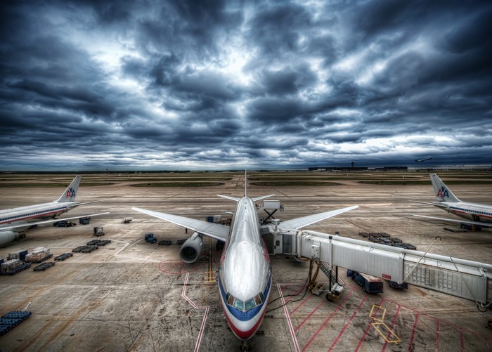 American Airlines airplanes at airport under stormy sky