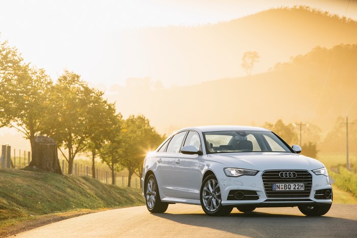 White Audi A6 Sedan on a road at sunset