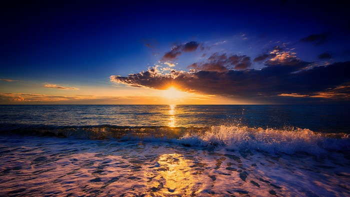 Sunset over the ocean with waves