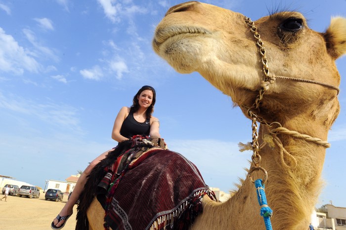 Woman riding a camel