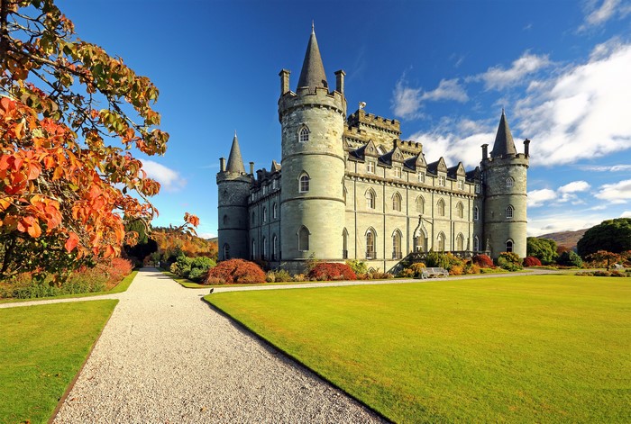 Castle in autumn park with colorful trees